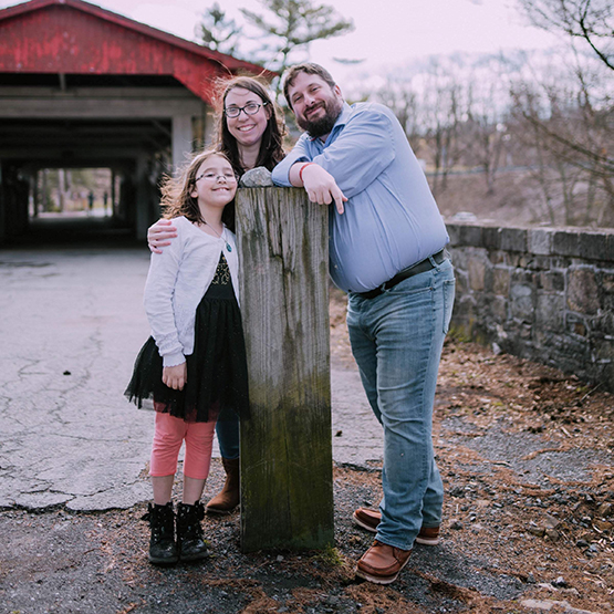 Lily and her family standing in front of a house