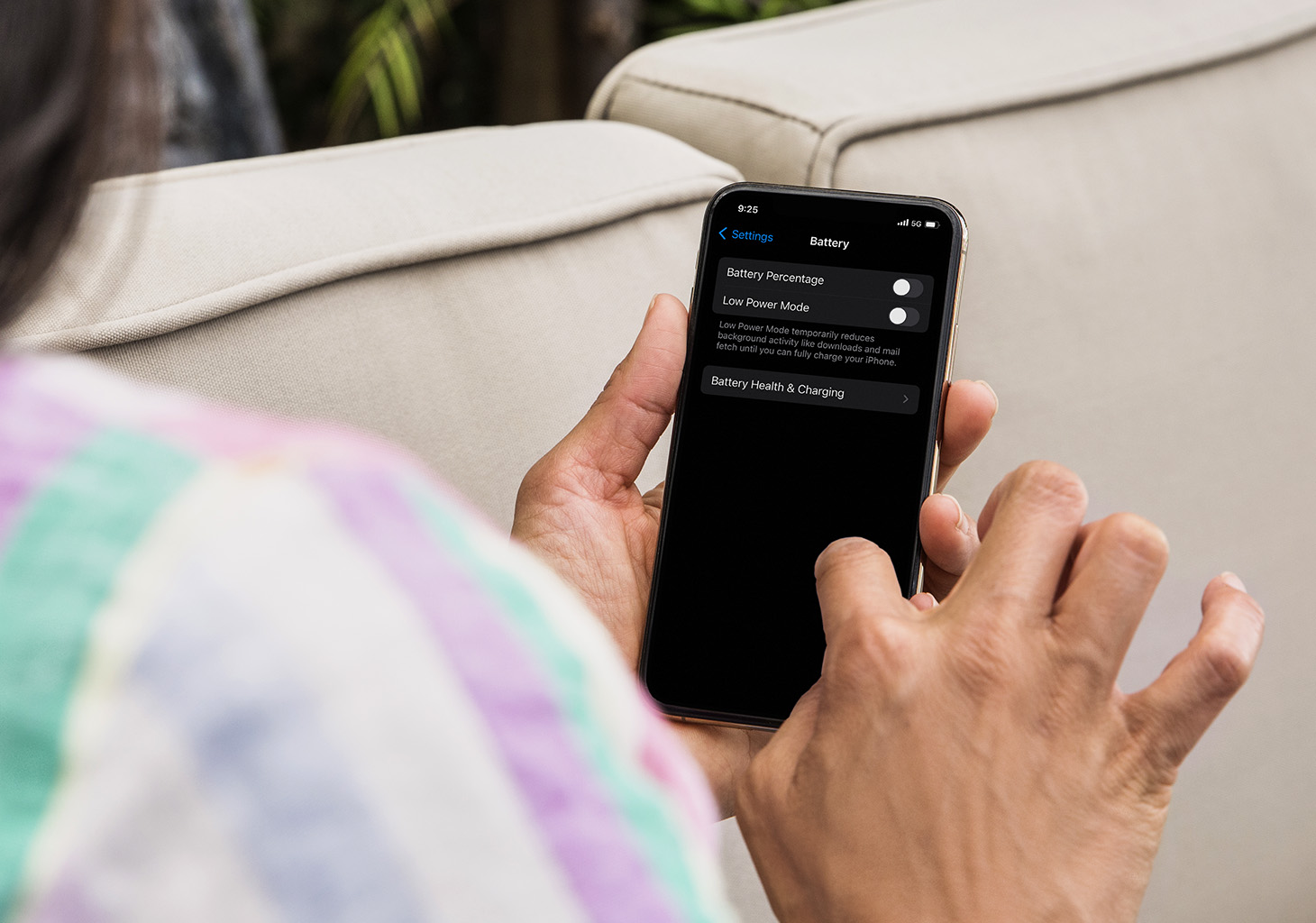 Woman Updating Lower Power Mode in iOS Settings