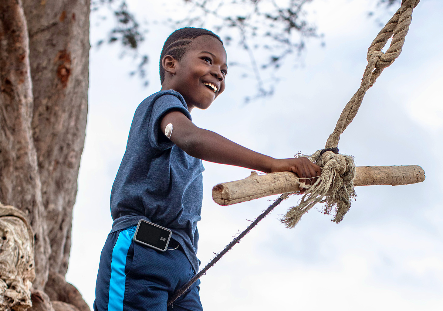 Young Boy Swinging with t:slim X2 Insulin Pump and Dexcom G7 Sensor