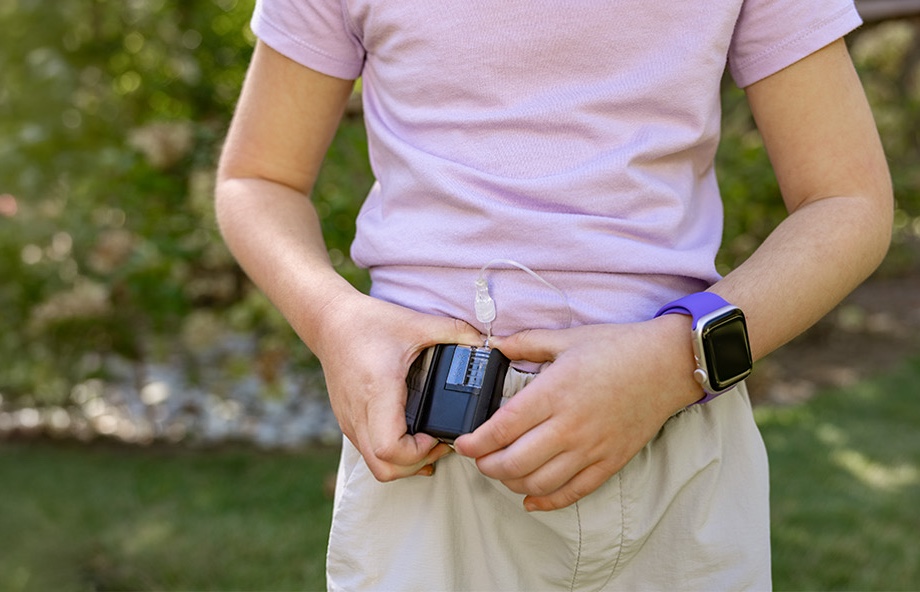 Child holding their Tandem Mobi pump