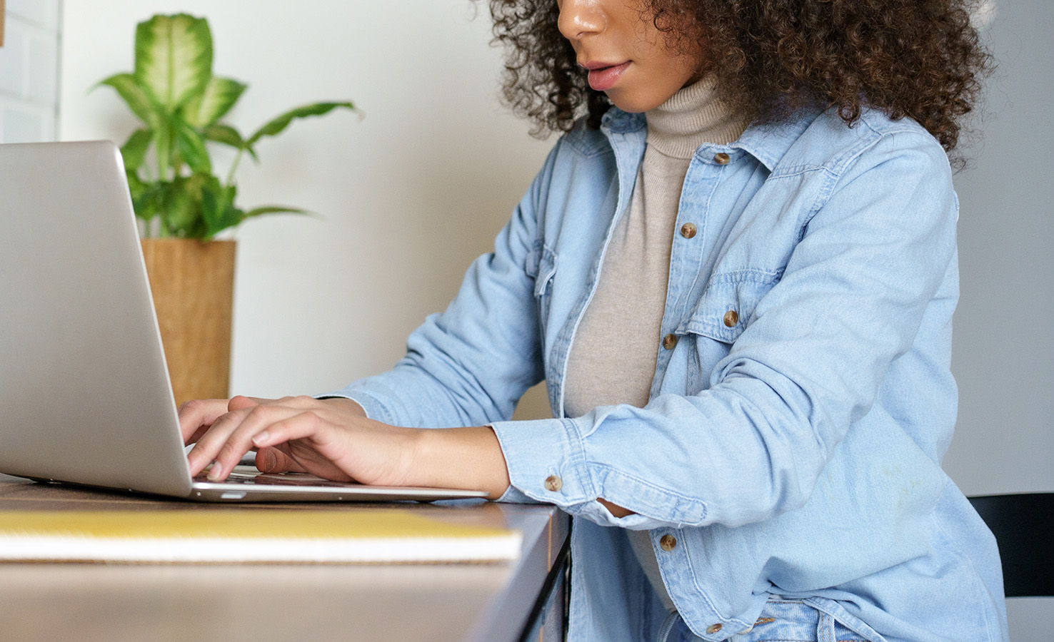 Woman clicking on laptop screen