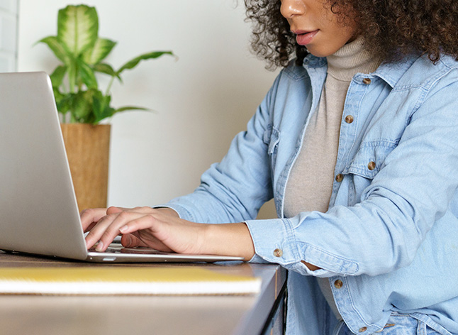 Woman clicking on laptop screen